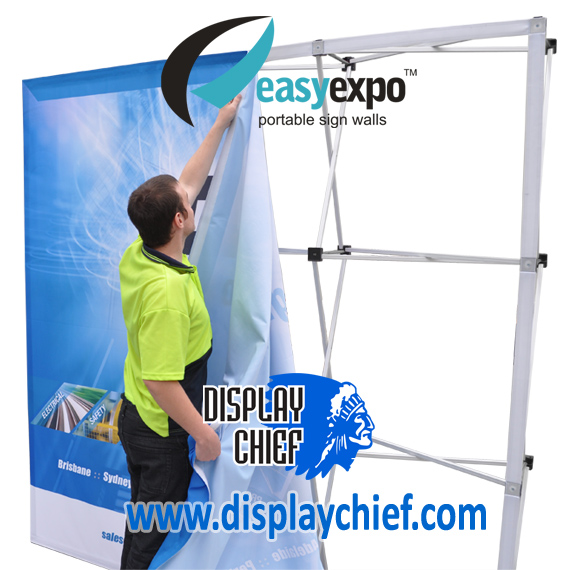 Man putting up sign onto the Easy Expo Display Chief pop up banner sign wall display system